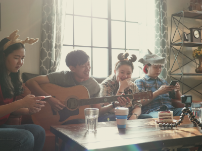 Happy asian people playing guitar at home.Group of Hipster asian people working with influencer,